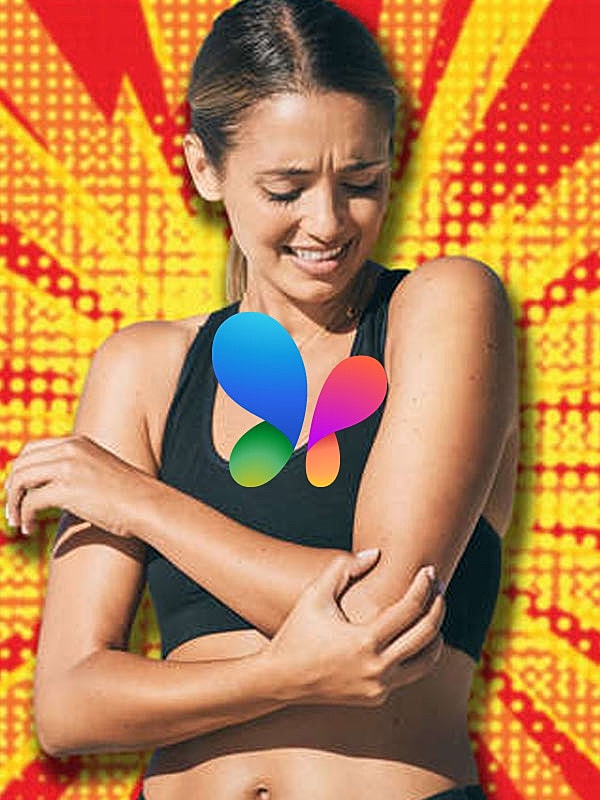 Woman holding her arm in discomfort.