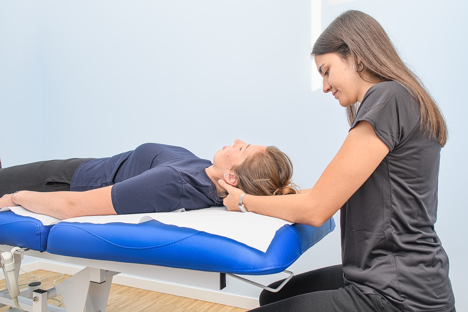 Physical therapy session between two women.