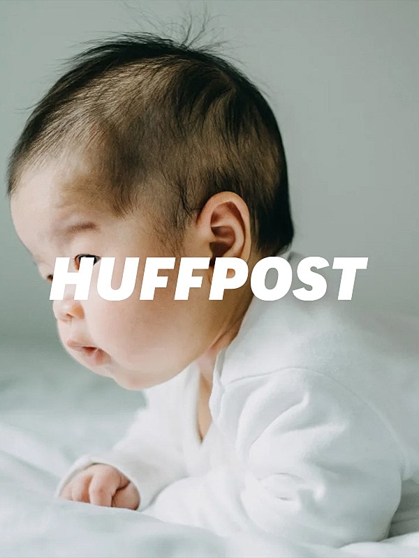 Baby peacefully exploring on a soft surface.