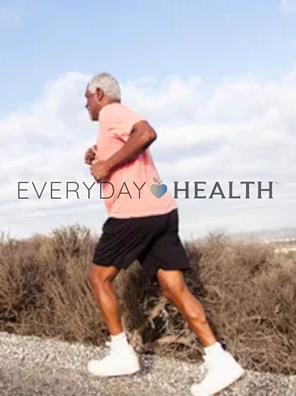 Older man jogging outdoors for fitness.