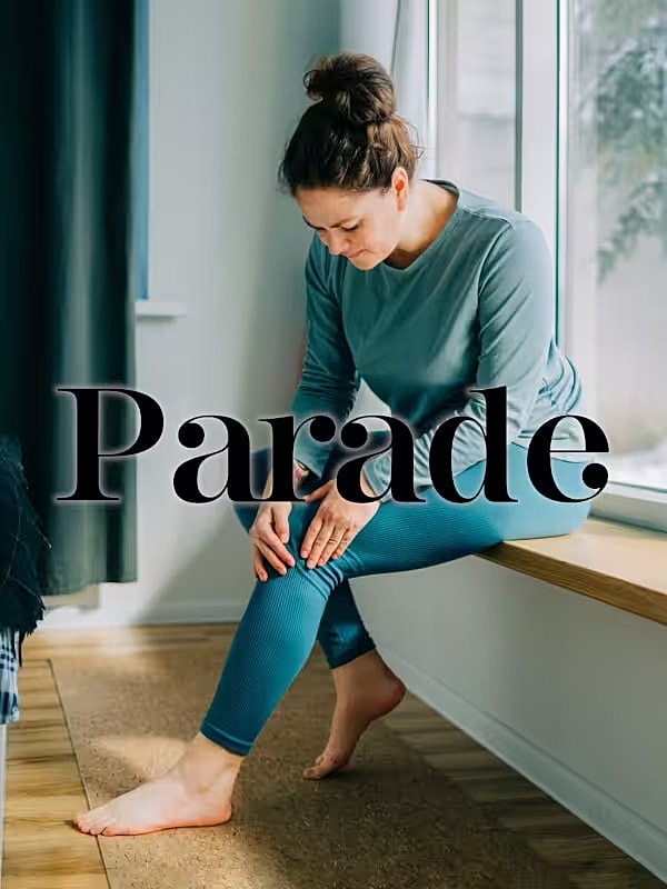 Woman sitting by window in casual wear.
