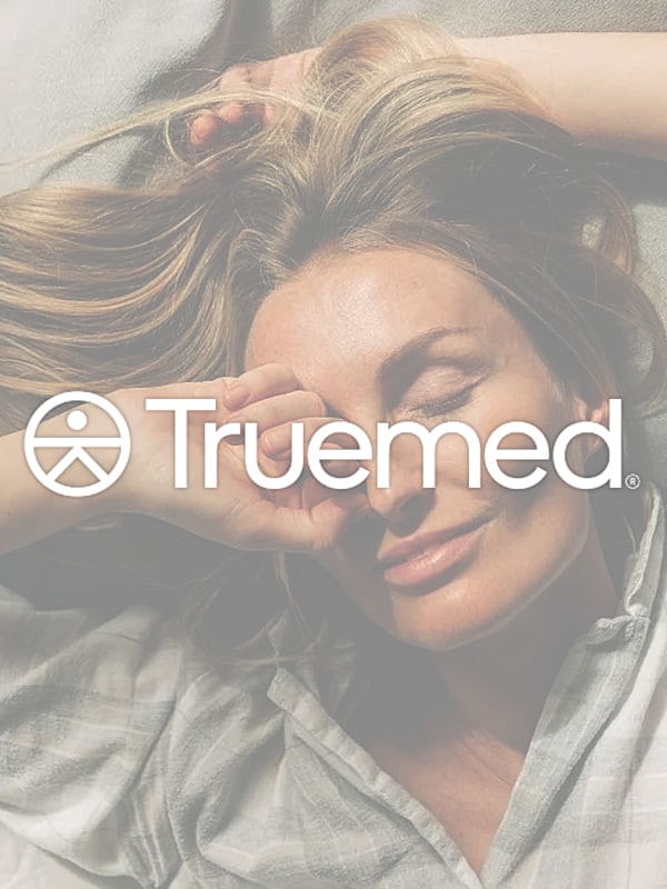 Woman relaxing with hand on face, TrueMed logo.