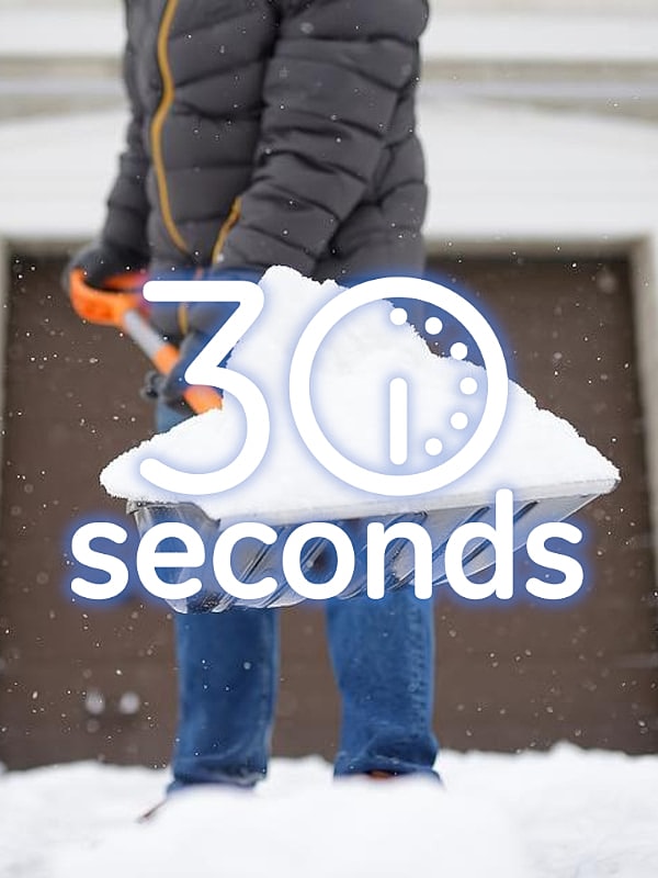 Person shoveling snow with timer overlay.
