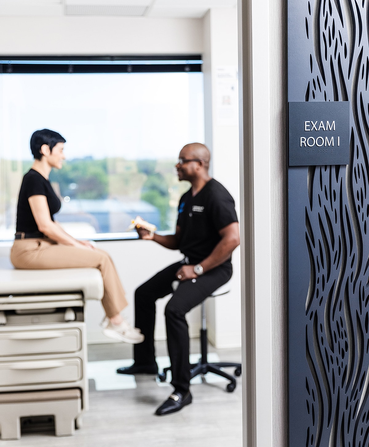 Disc replacement surgery consultation in a medical exam room.