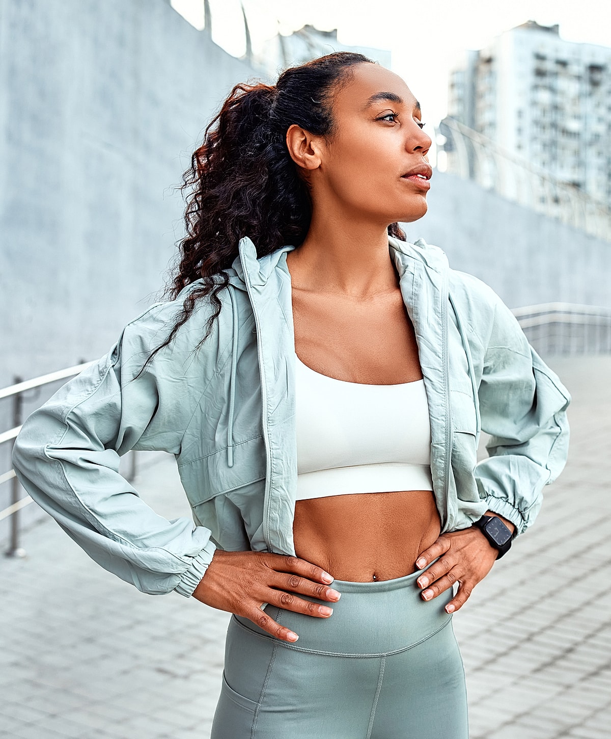 Athletic neck paint patient model in light activewear outdoors.