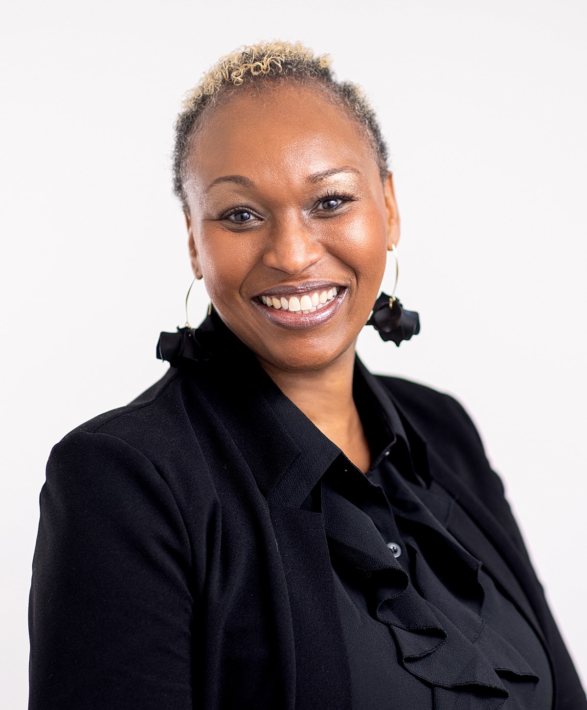 Smiling professional woman in elegant attire.