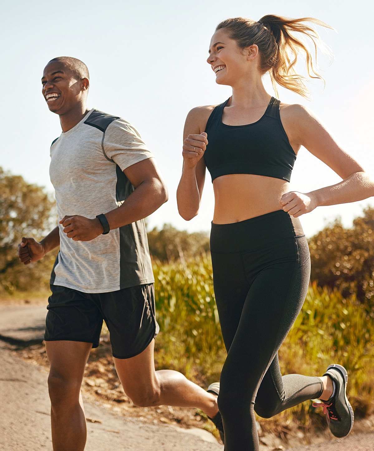 robotic spine surgery patient models jogging together outdoors in sunny weather.