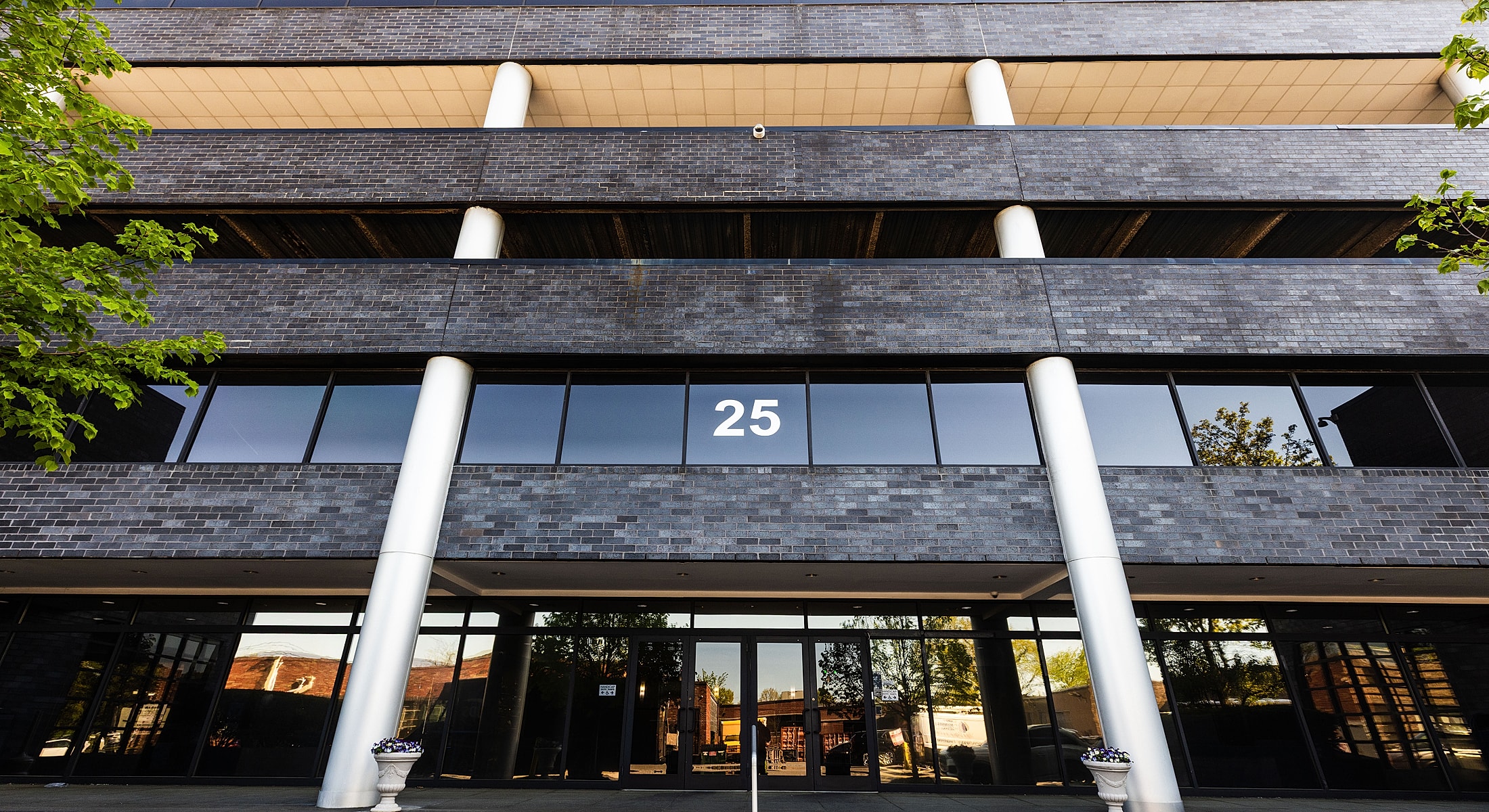 Modern building facade with number 25 displayed.