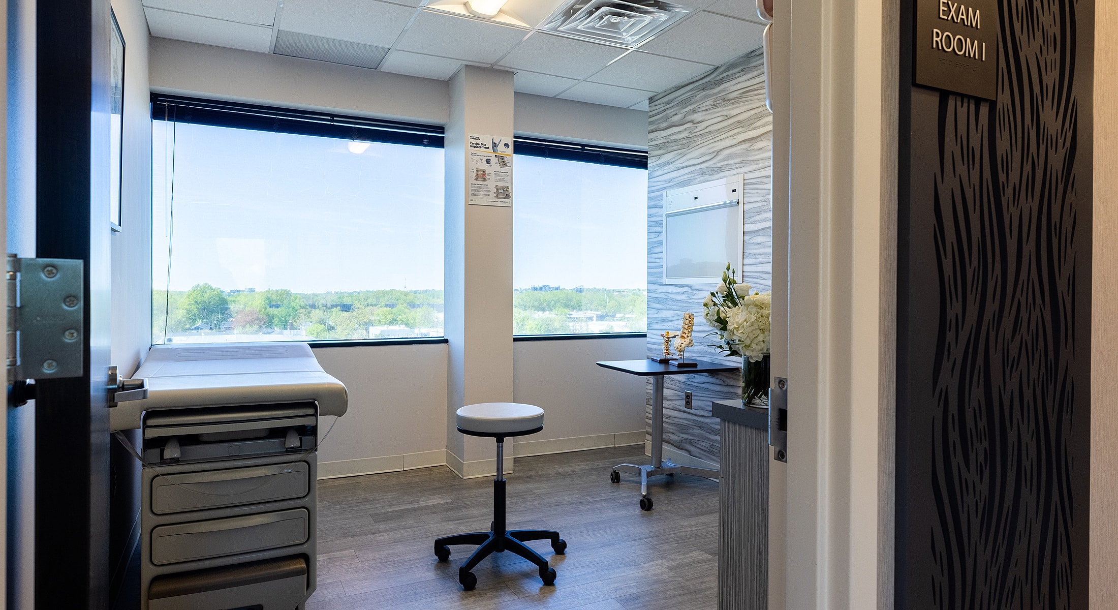 Bright, modern medical exam room with windows.