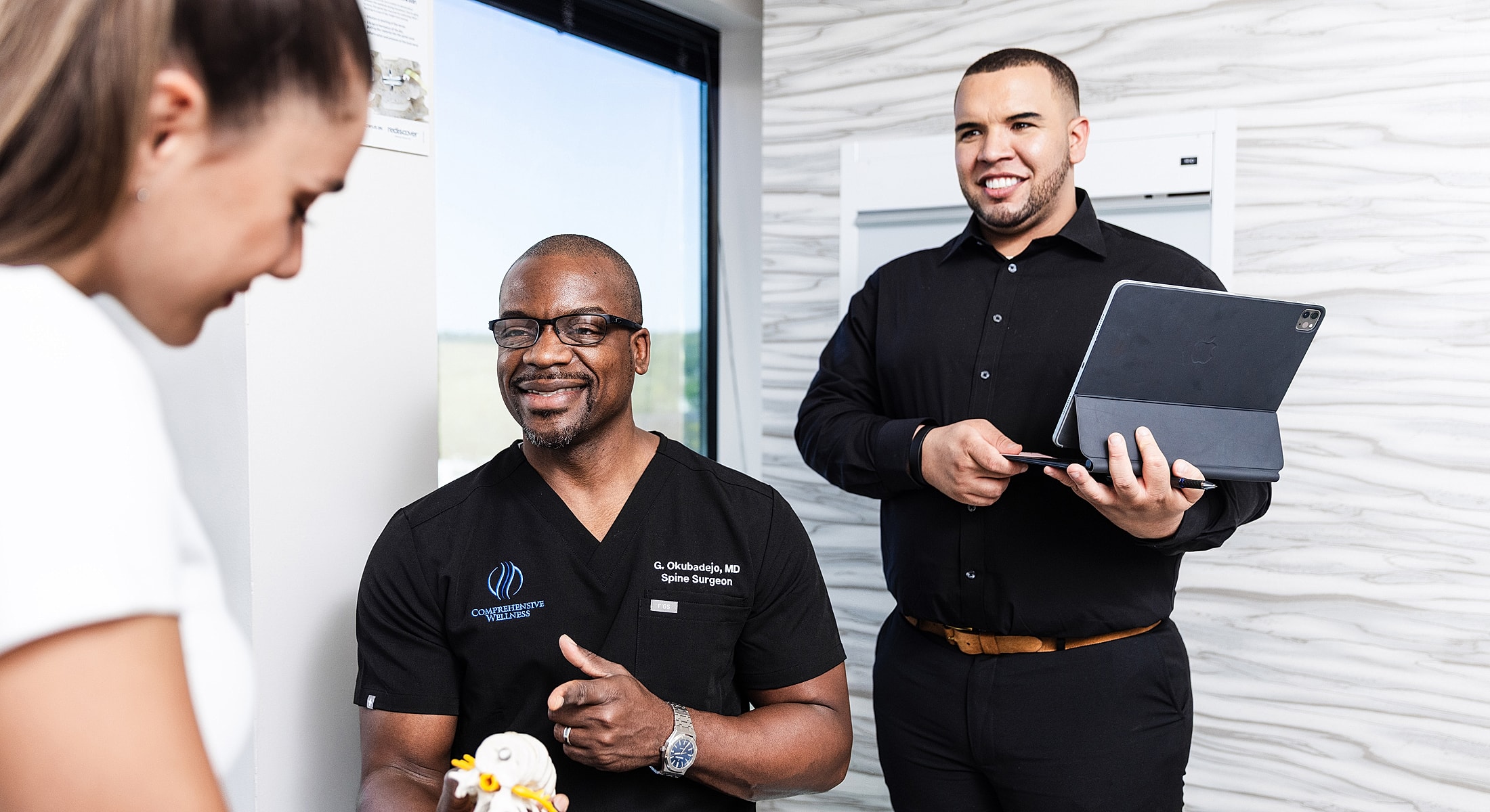 spine surgeon consulting with patient about lumbar microdiscectomy in medical office.