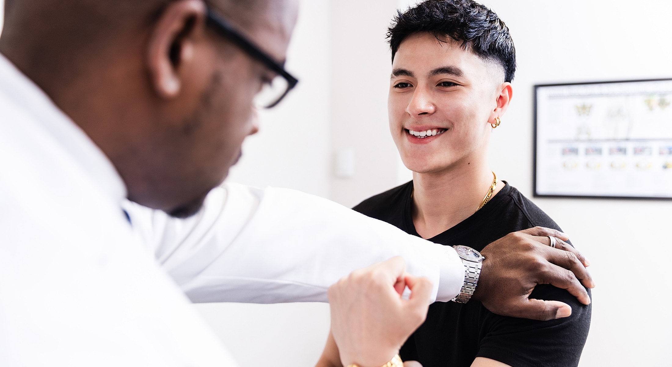 spine surgeon examining scoliosis treatment patient in medical office setting.